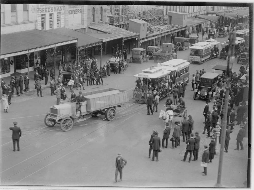Procession Of Truck In Front Of North Carlton Tram Being Watched By A Large Group Of People