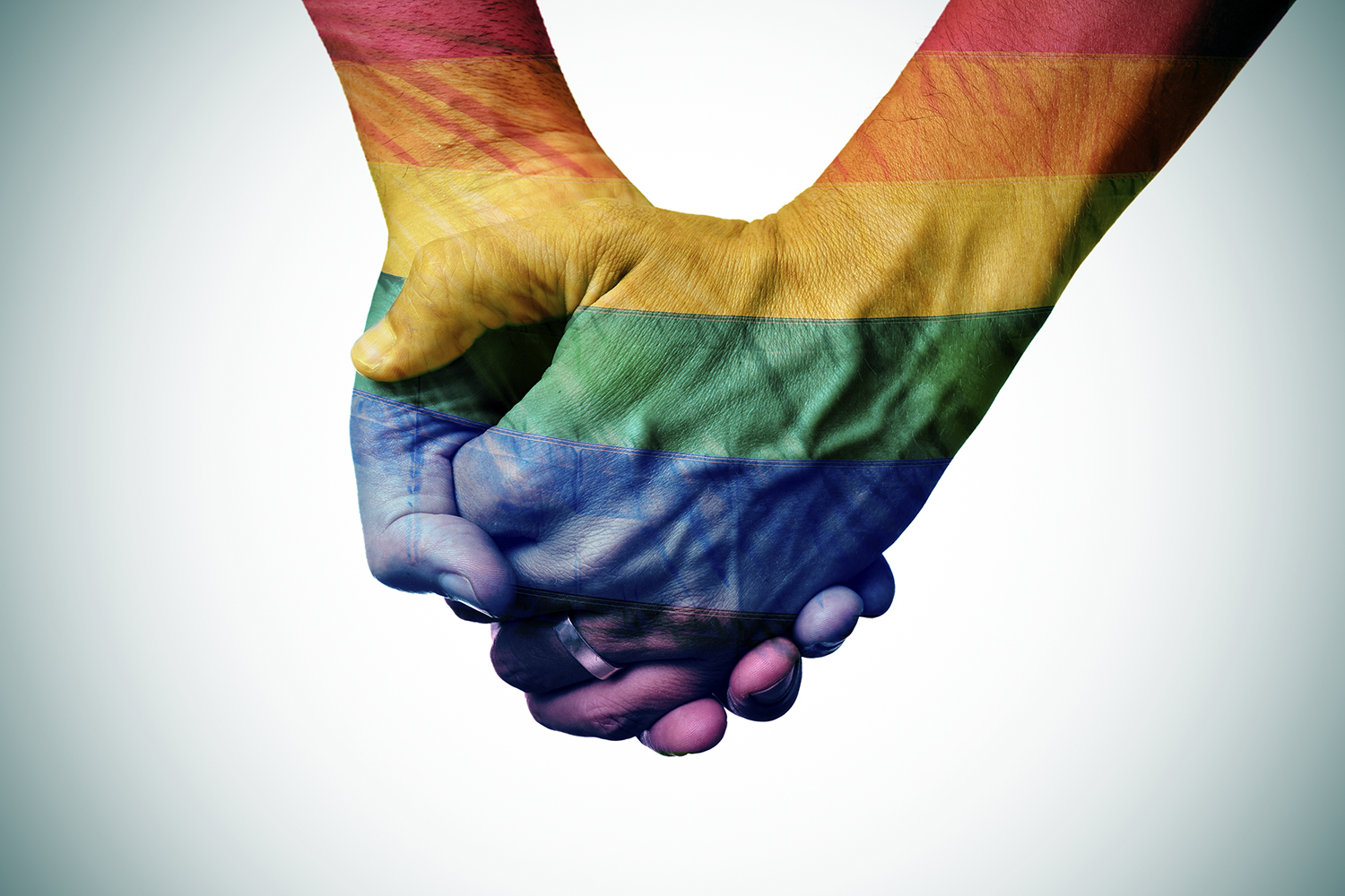 Holding hands coloured like a rainbow flag