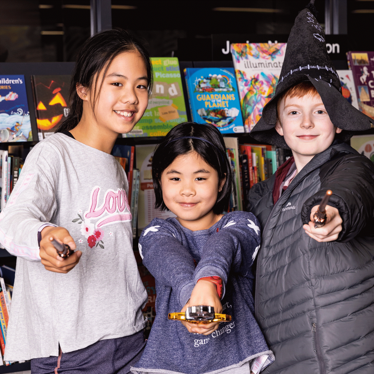 Three children in costume, participating in the summer reading program.